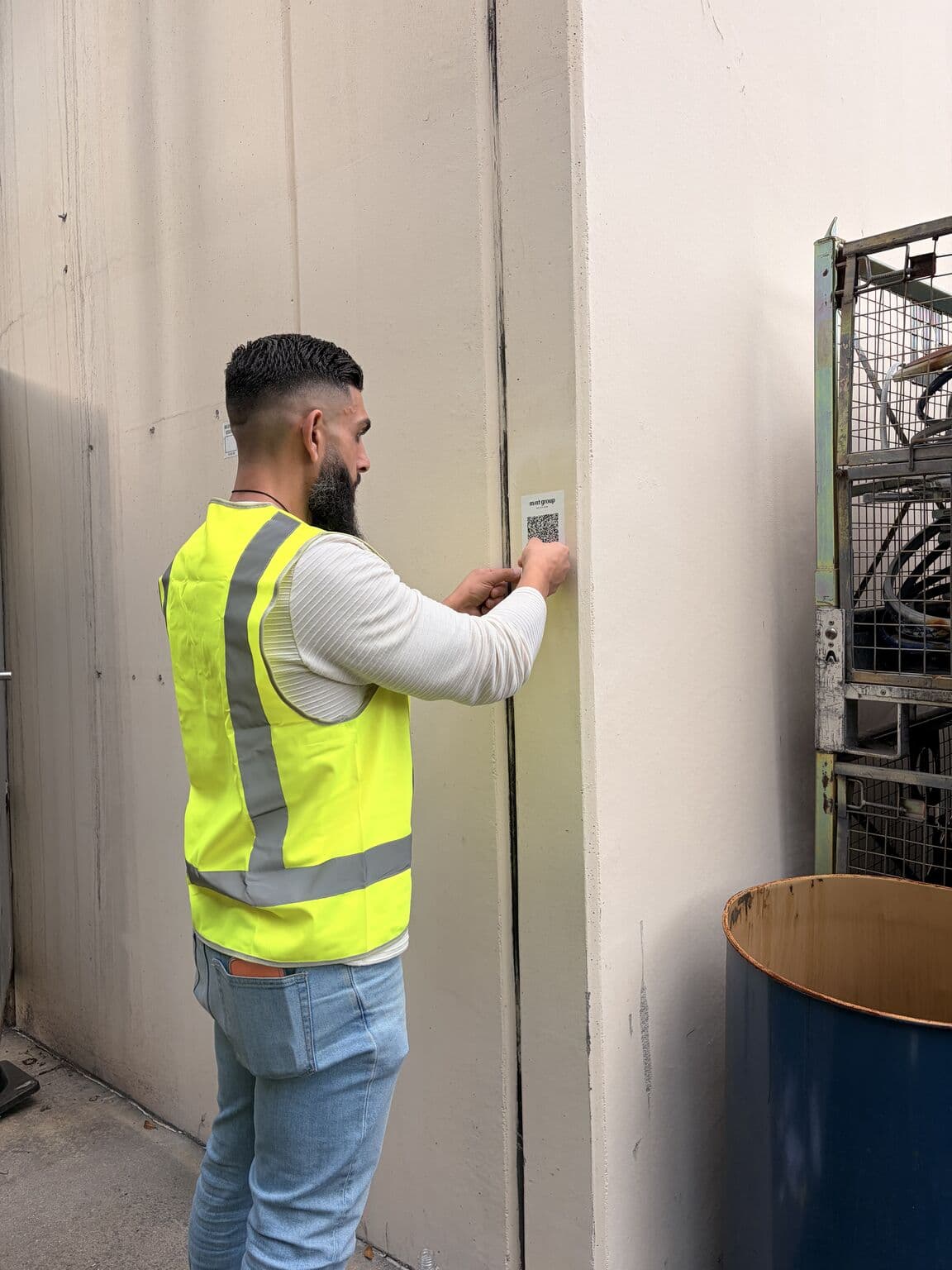 GuardSync's COO installing a checkpoint QR code at Sircel Recycling Facility during deployment